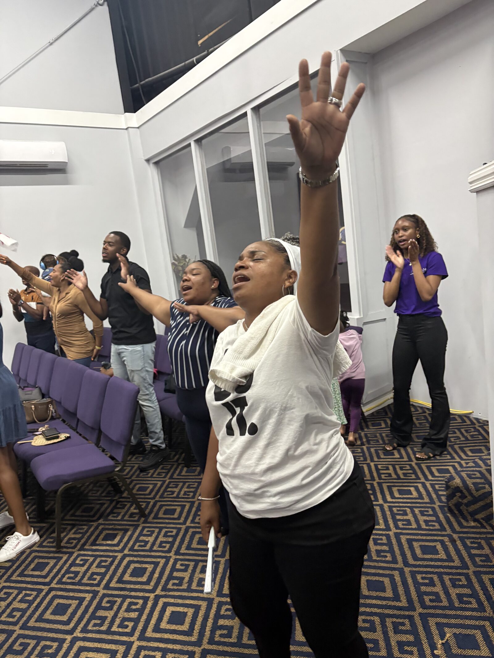 Worshiper with raised hands during Praise Break